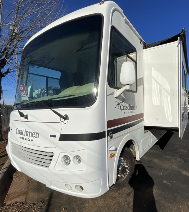 Driver's side view of 2012 Coachmen Mirada 34BH with slide-out extended