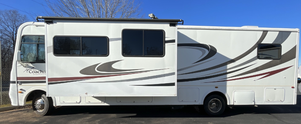 Side profile view of 2012 Coachmen Mirada 34BH with slide-out extended