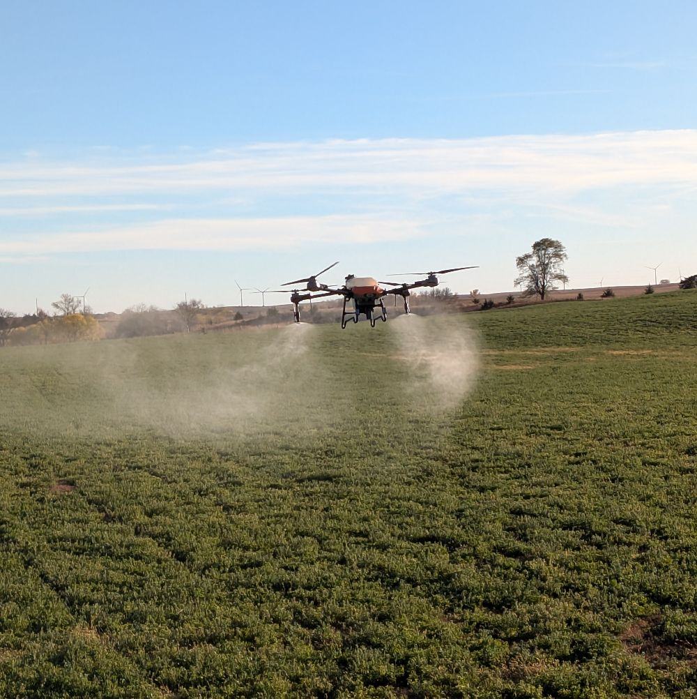 Spray drone in action over agricultural field