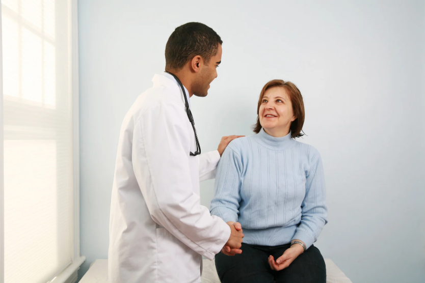 Healthcare provider in compassionate consultation with patient in a calm, bright clinical setting