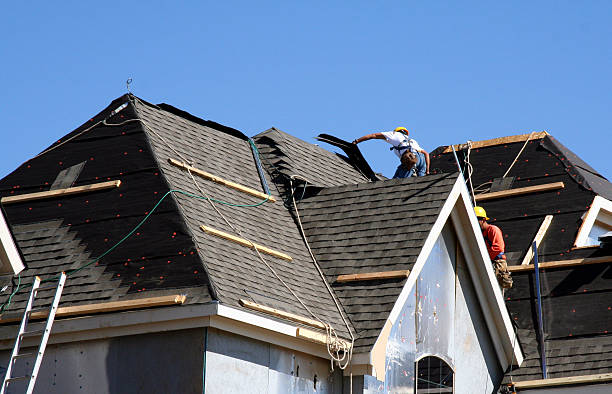 Professional roofing crew installing new shingles on residential home in Abilene TX