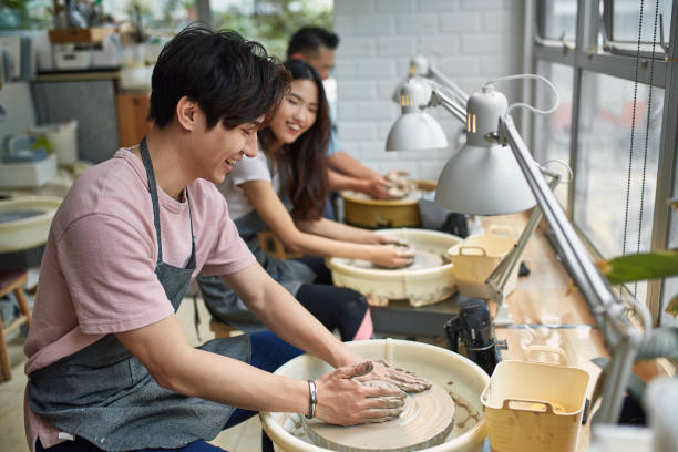 Creative ceramics workshop with people shaping clay and pottery