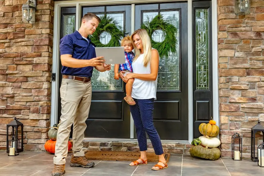 Eastline Pest Management technician consulting with family at home in New Bern NC