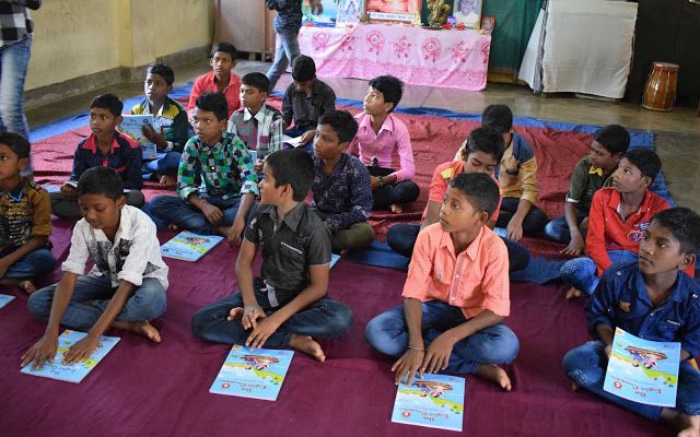 Students sitting with educational materials and books