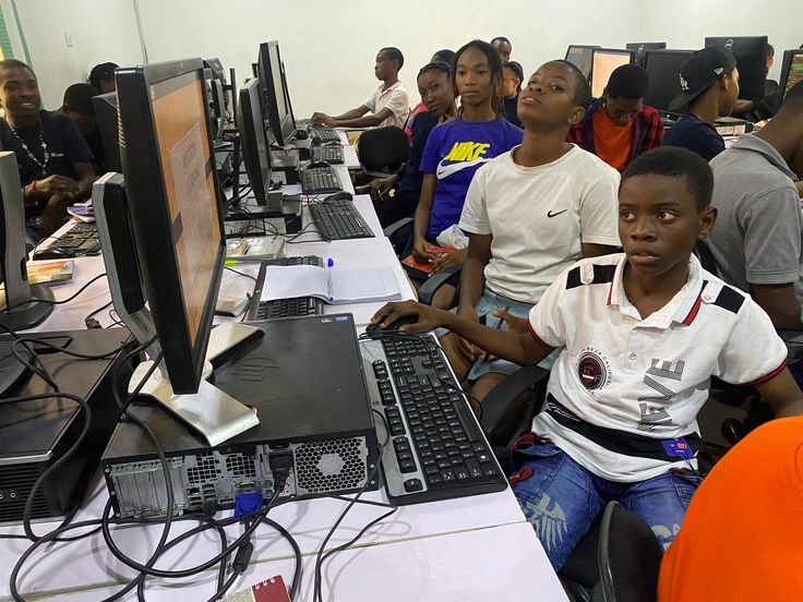 Students working on computers in a computer lab, learning digital skills