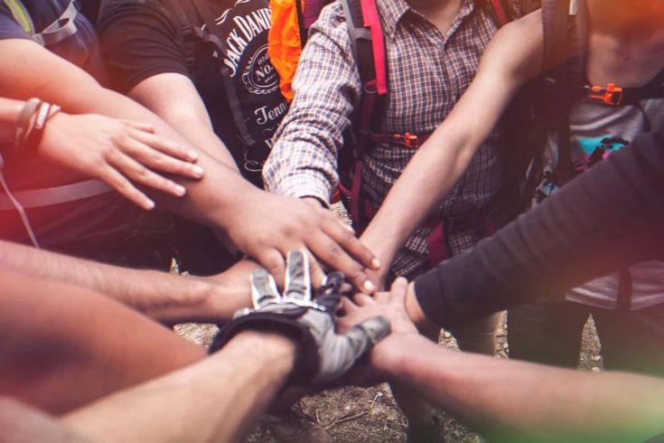 Hands coming together in unity and teamwork