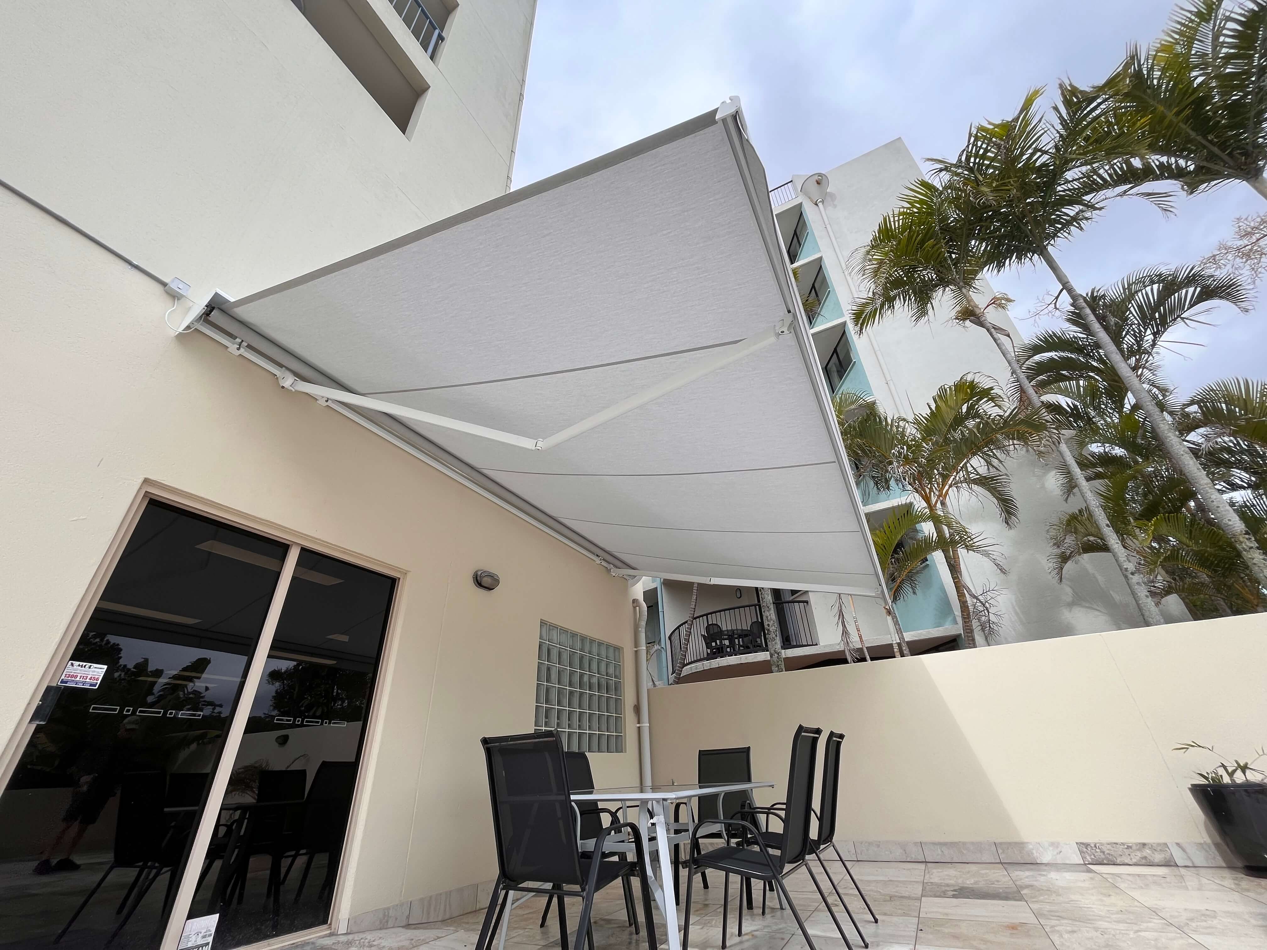 Standard folding arm awning providing shade for an outdoor dining setting