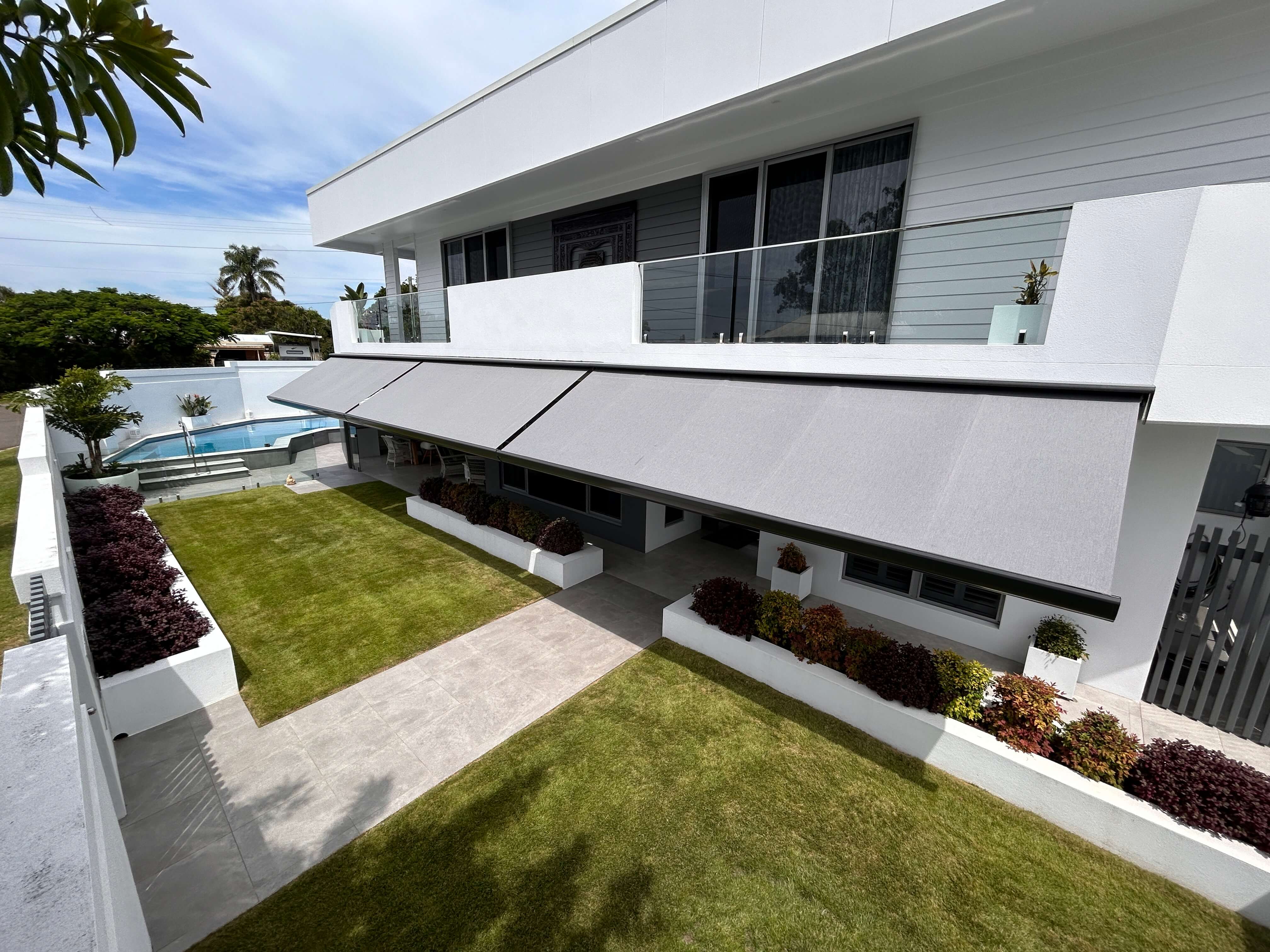 Semi-cassette folding arm awning on modern home