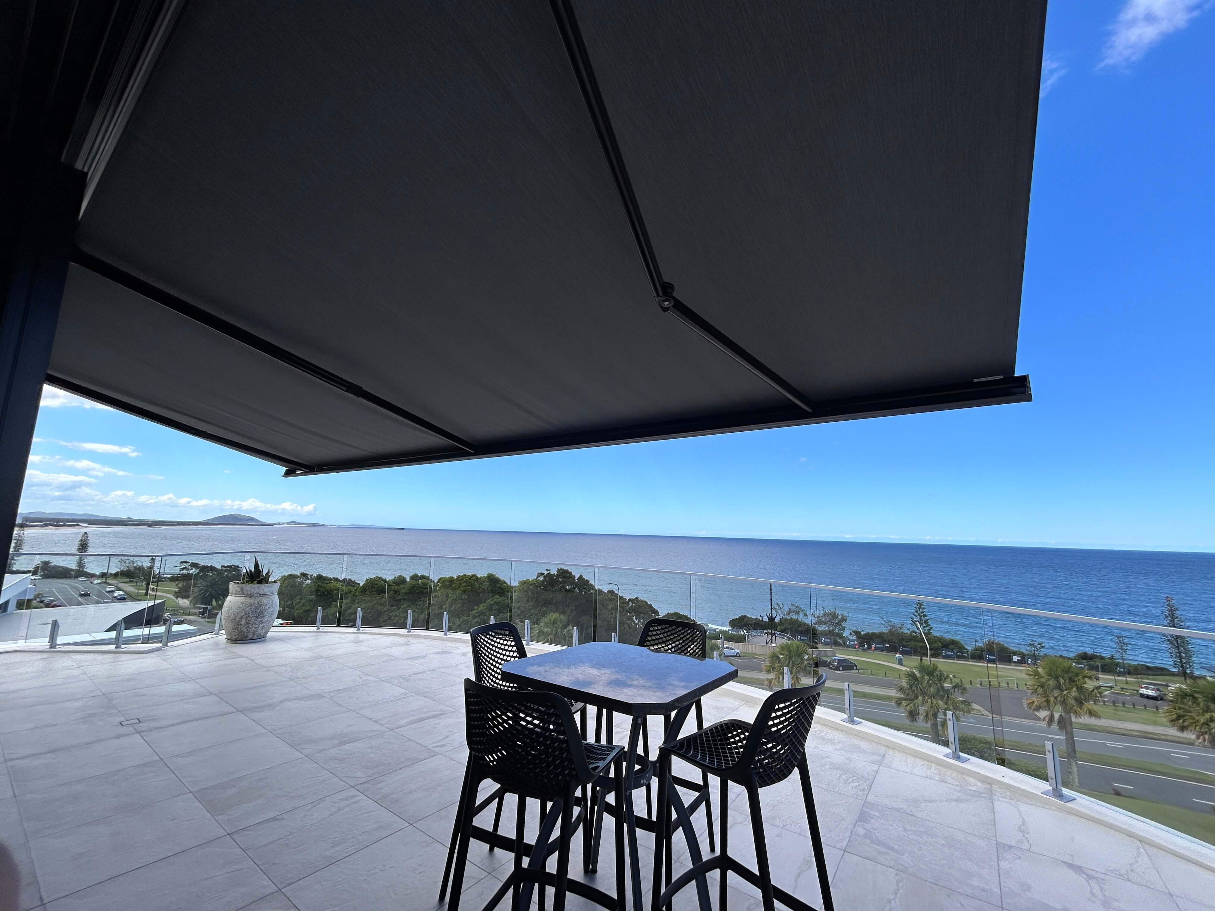 Full cassette folding arm awning on ocean balcony