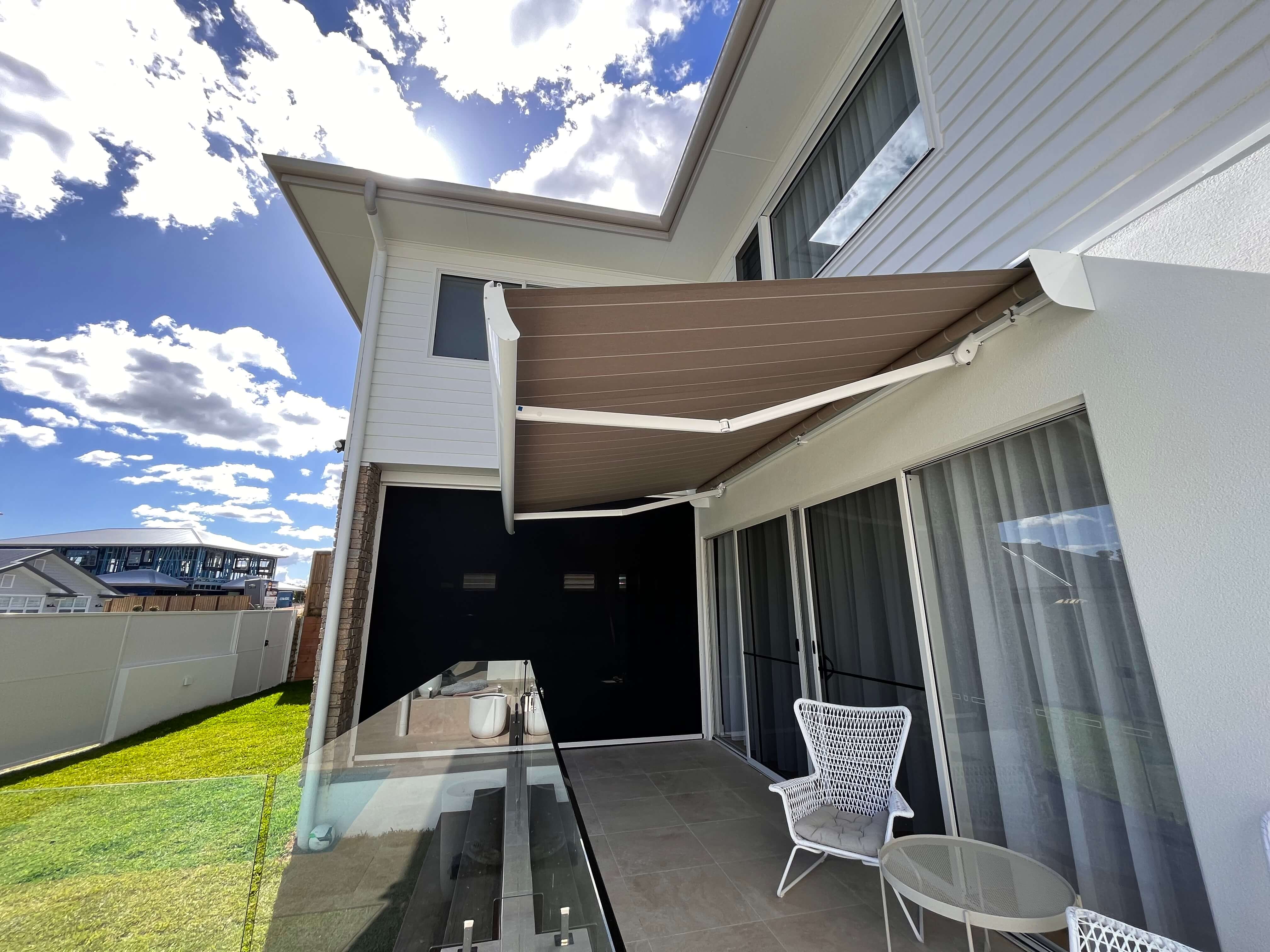 Siena semi-cassette awning extending over a comfortable patio area
