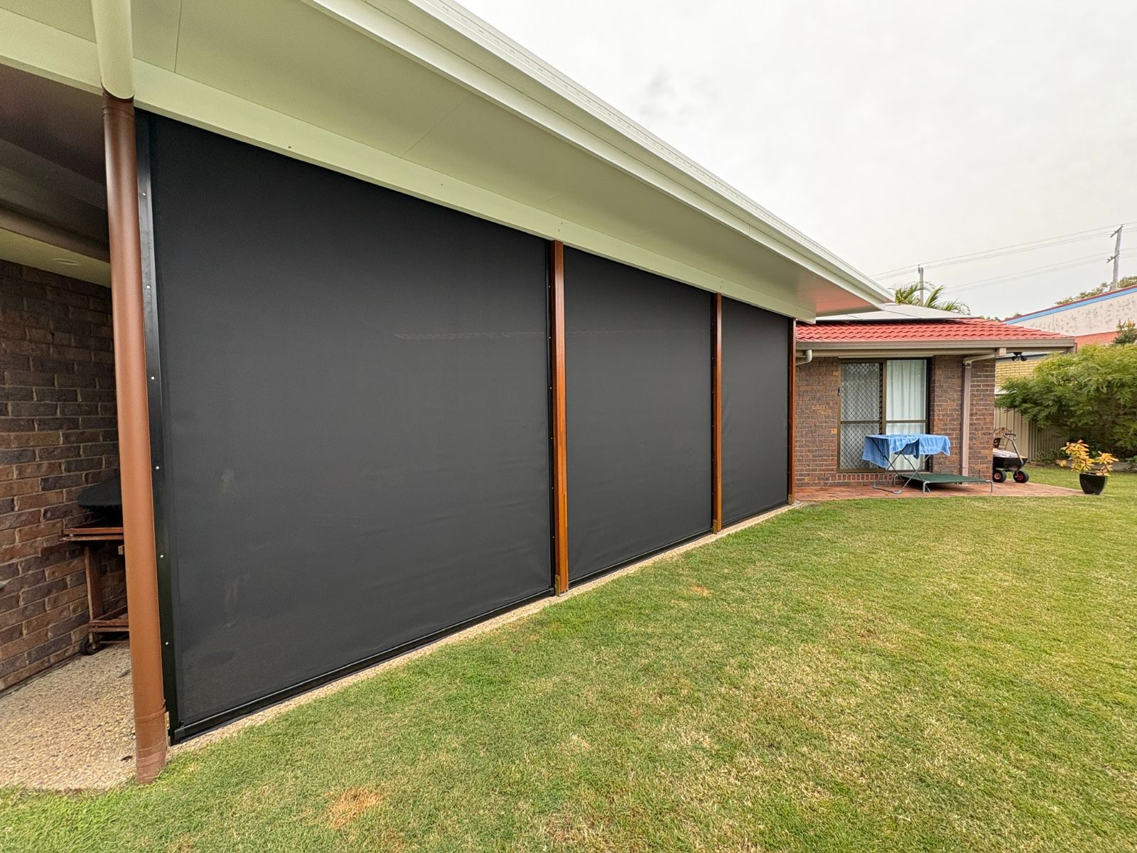 Ziptrak outdoor blinds fully lowered on exterior patio - Sunshine Coast