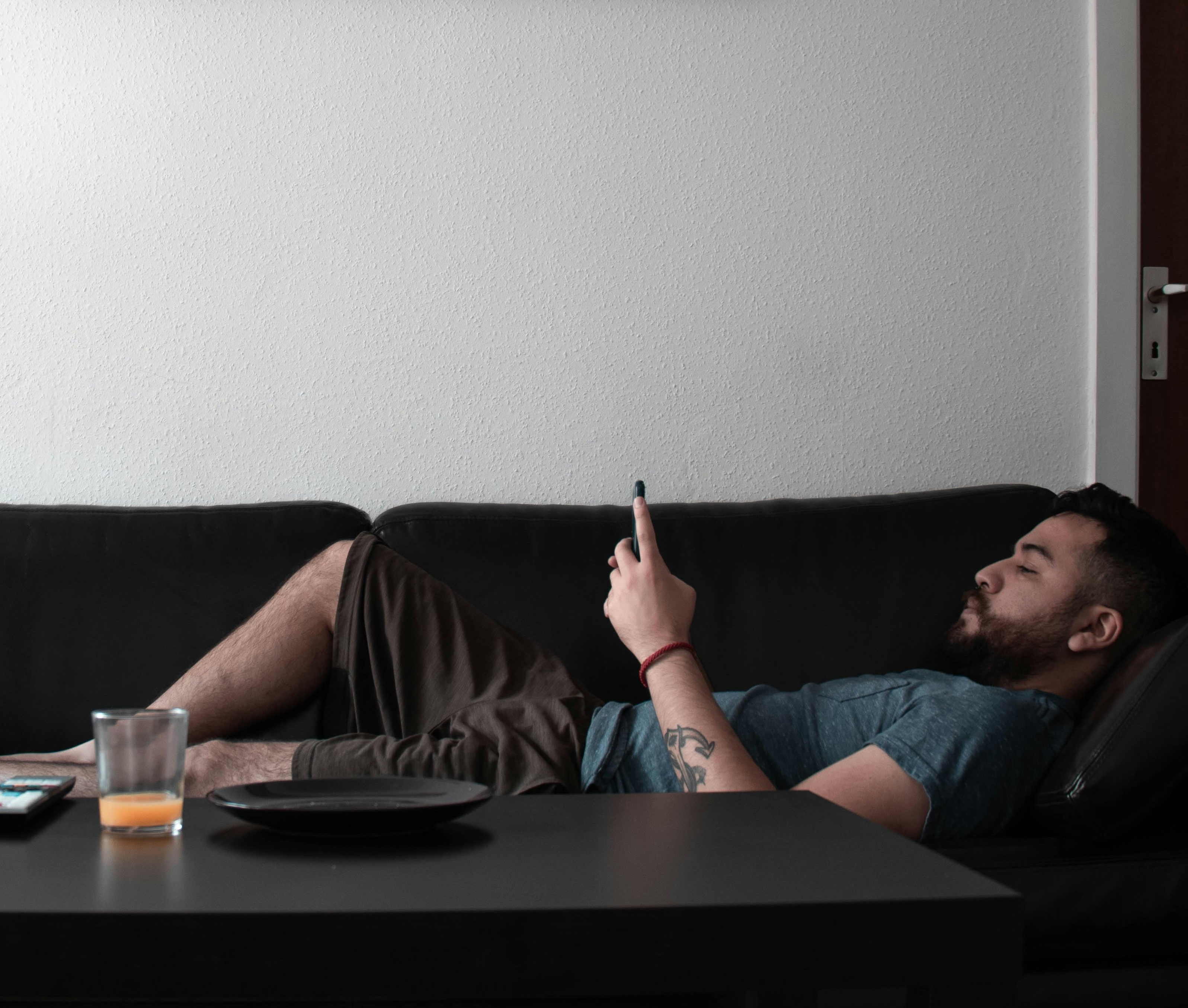 Professional relaxing on couch using phone