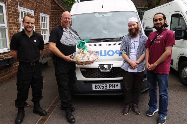 Police van community outreach with gift presentation