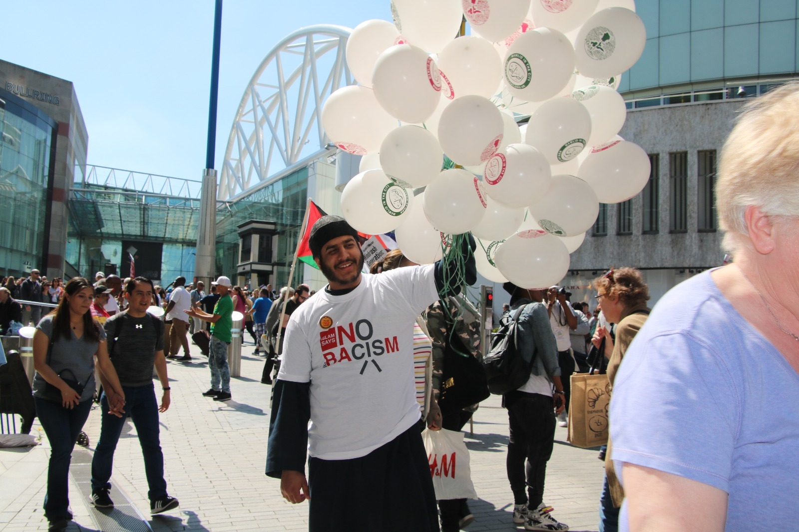Community member at anti-racism demonstration with balloons